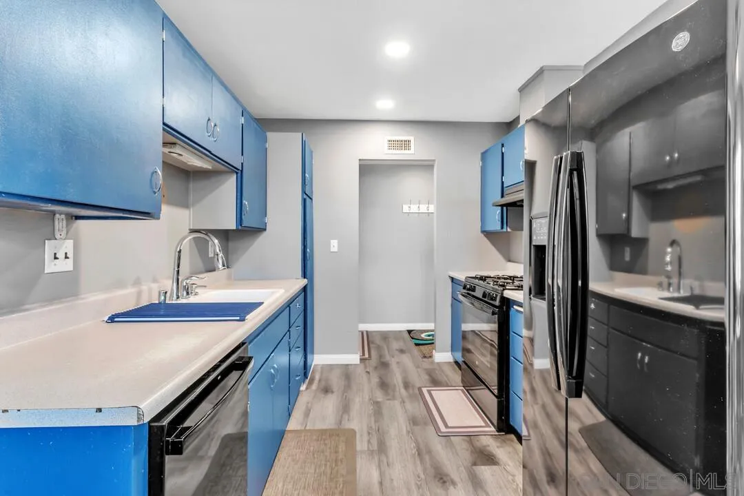 13611 Los Coches Road East El Cajon, CA 92021 - Photo 7 of 34 a kitchen with granite countertop a sink stove and refrigerator