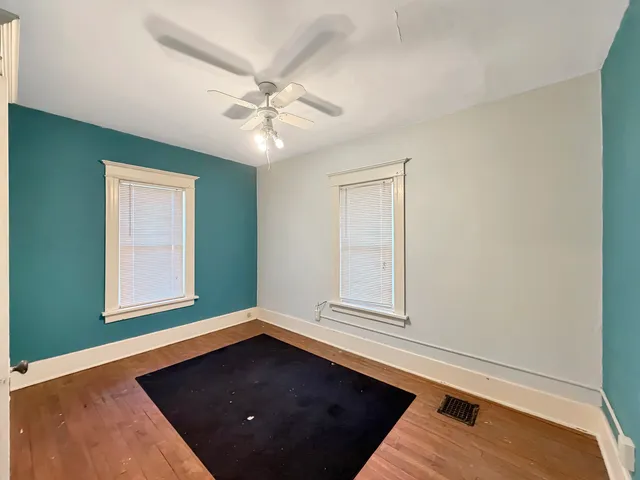 an empty room with windows and closet