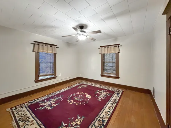a view of an empty room with window and a rug