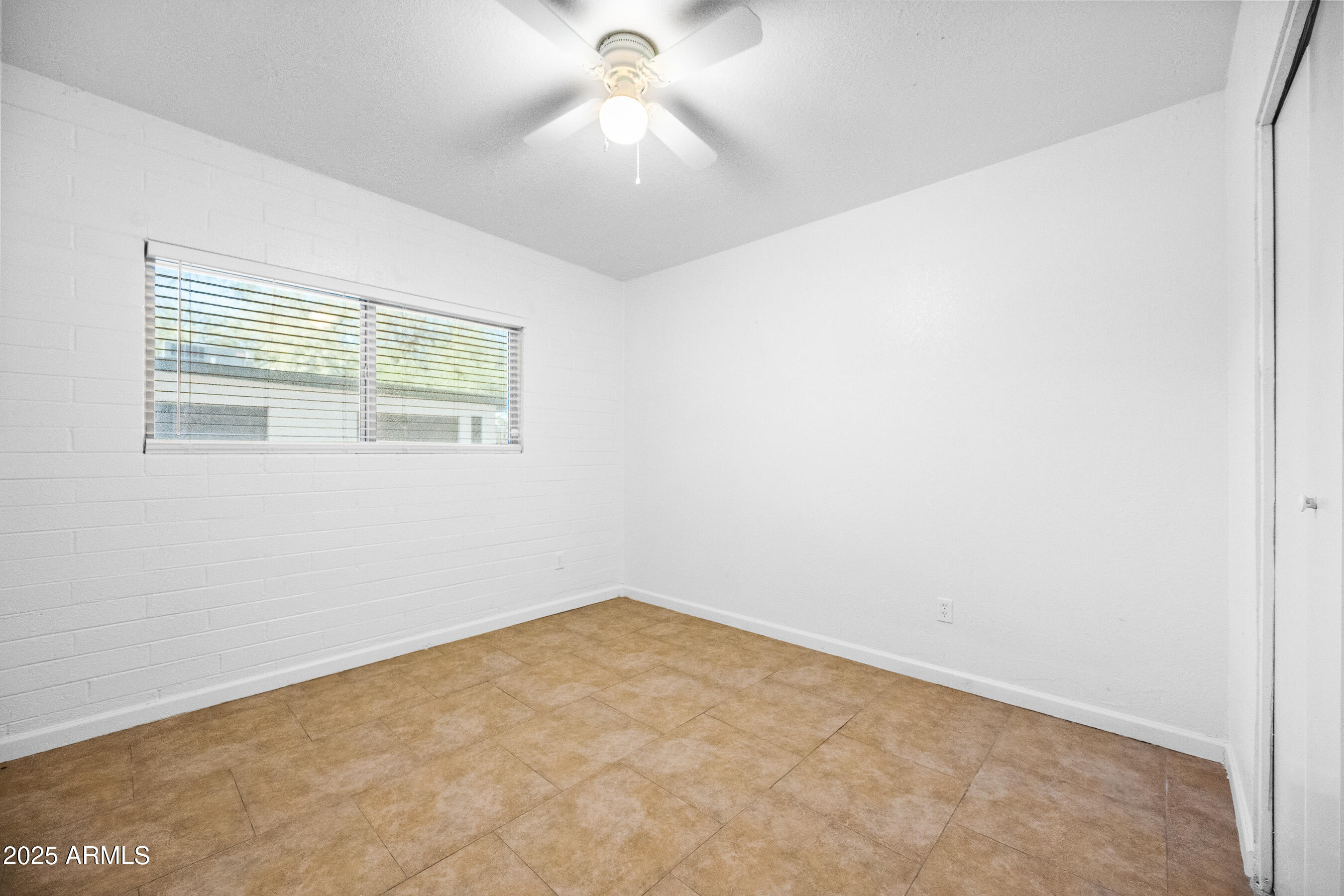 1518 West Colter Street, Unit 4 Phoenix, AZ 85015 - Photo 11 of 26 an empty room with a window