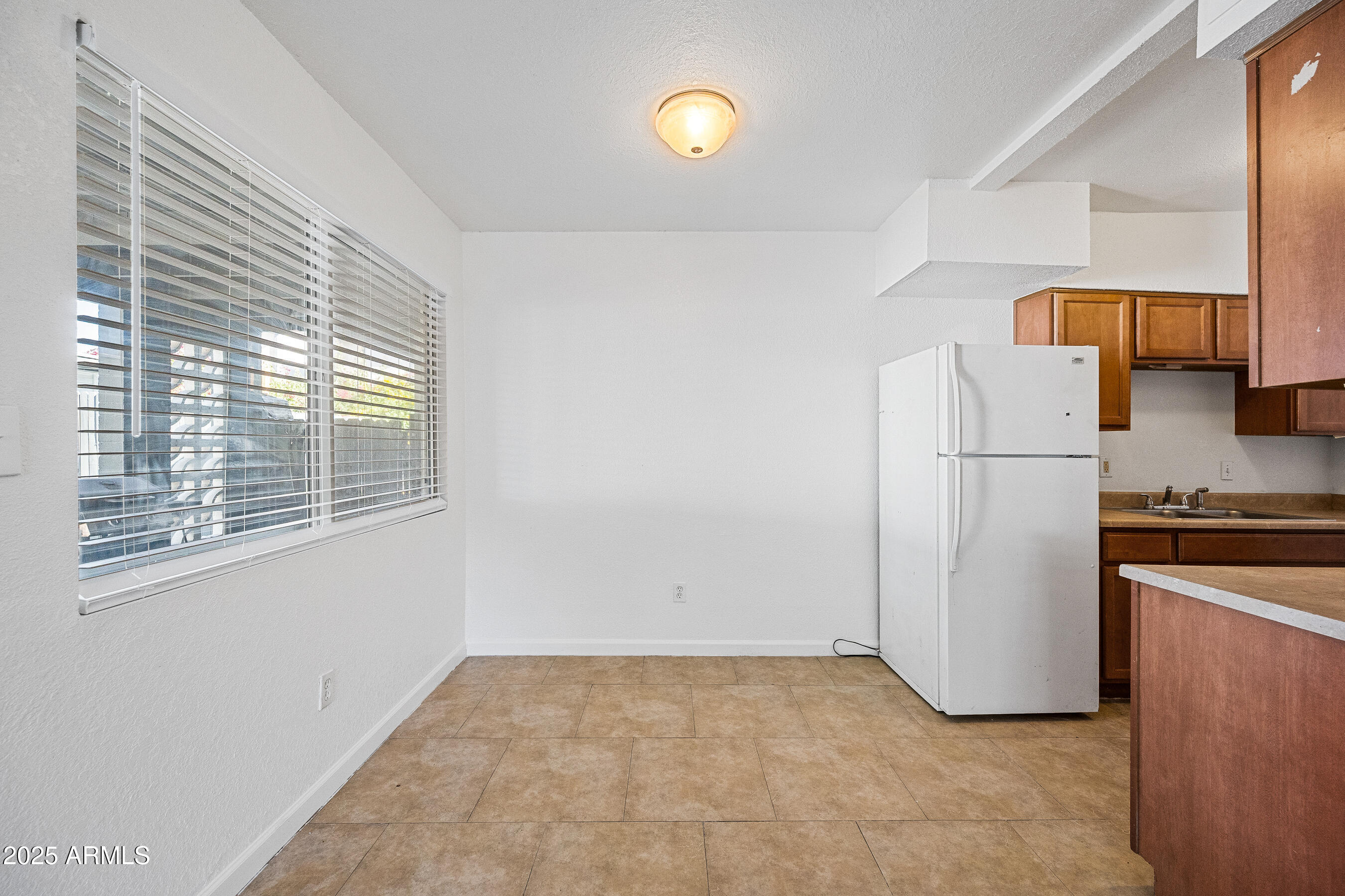 1518 West Colter Street, Unit 4 Phoenix, AZ 85015 - Photo 5 of 26 a view of a kitchen with a refrigerator cabinets and a window