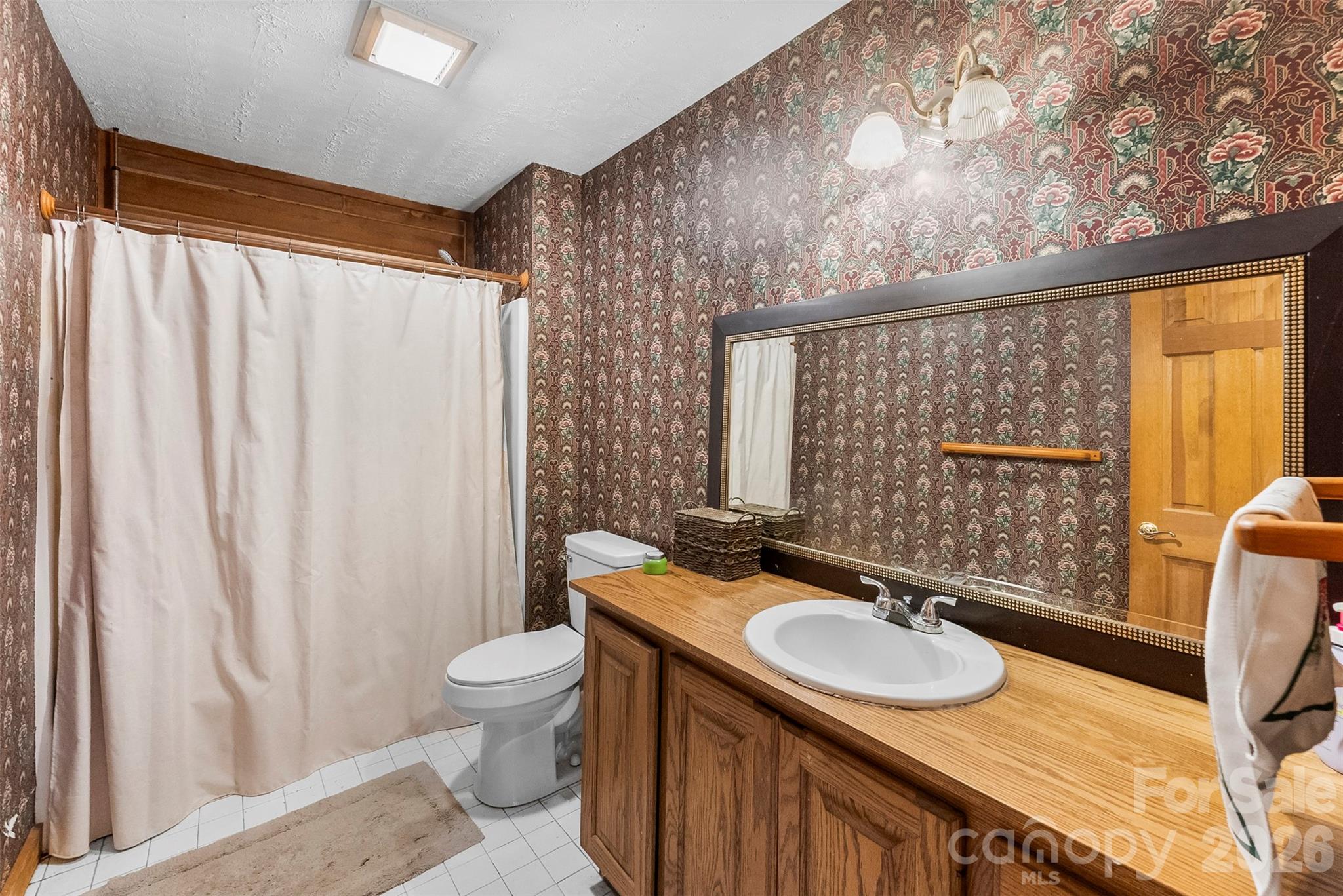 5011 Medlin Road Monroe, NC 28112 - Photo 18 of 37 a bathroom with a sink a toilet and a mirror
