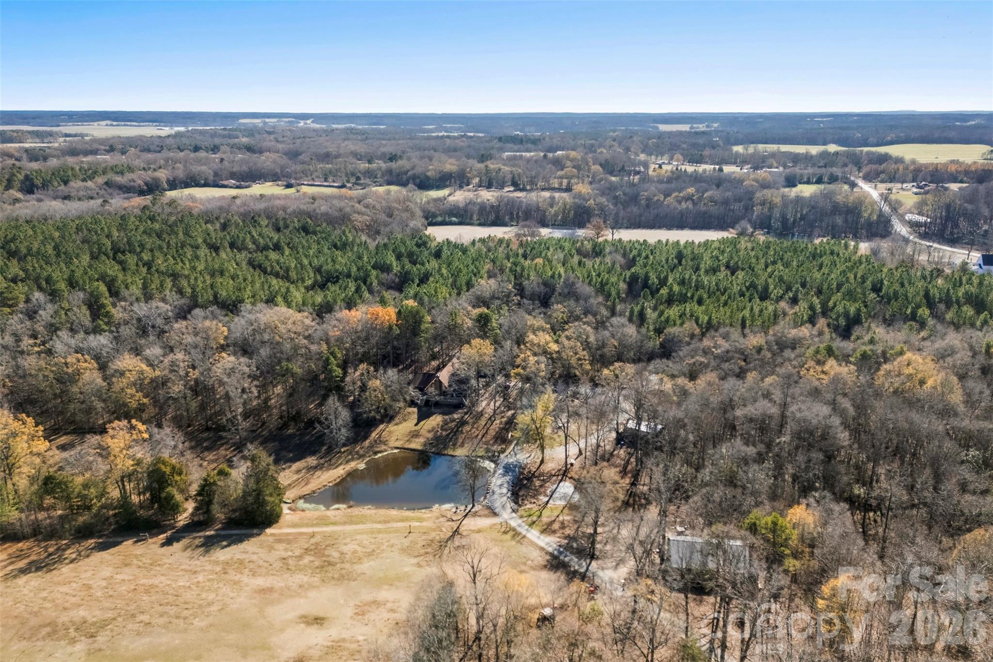 5011 Medlin Road Monroe, NC 28112 - Photo 33 of 37 an aerial view of houses covered in trees