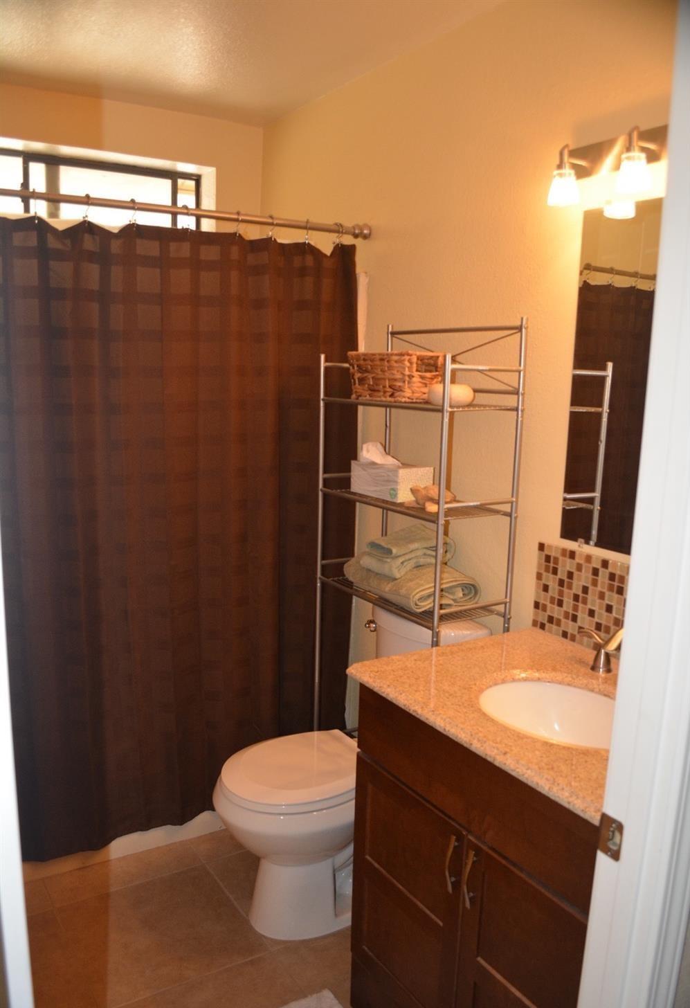 4780 Montiverde Road Mojave, CA 93501 - Photo 20 of 52 a bathroom with a sink a toilet a mirror and shower