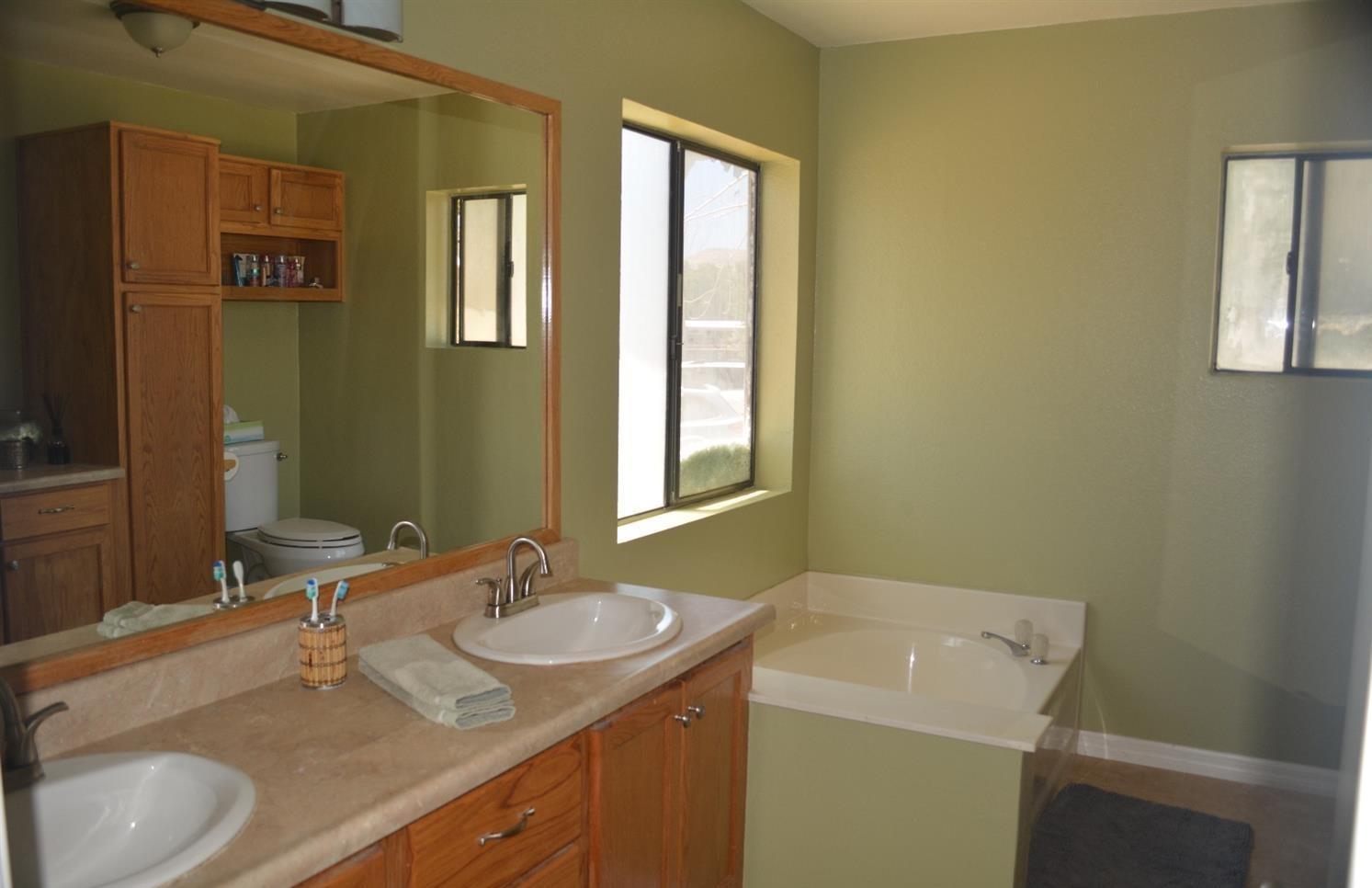4780 Montiverde Road Mojave, CA 93501 - Photo 21 of 52 a bathroom with a granite countertop sink and a mirror