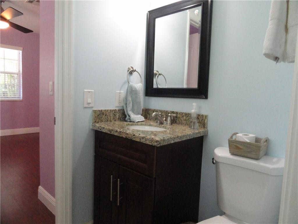17950 Southwest 55th Street Southwest Ranches, FL 33331 - Photo 13 of 31 a bathroom with a granite countertop sink and a mirror