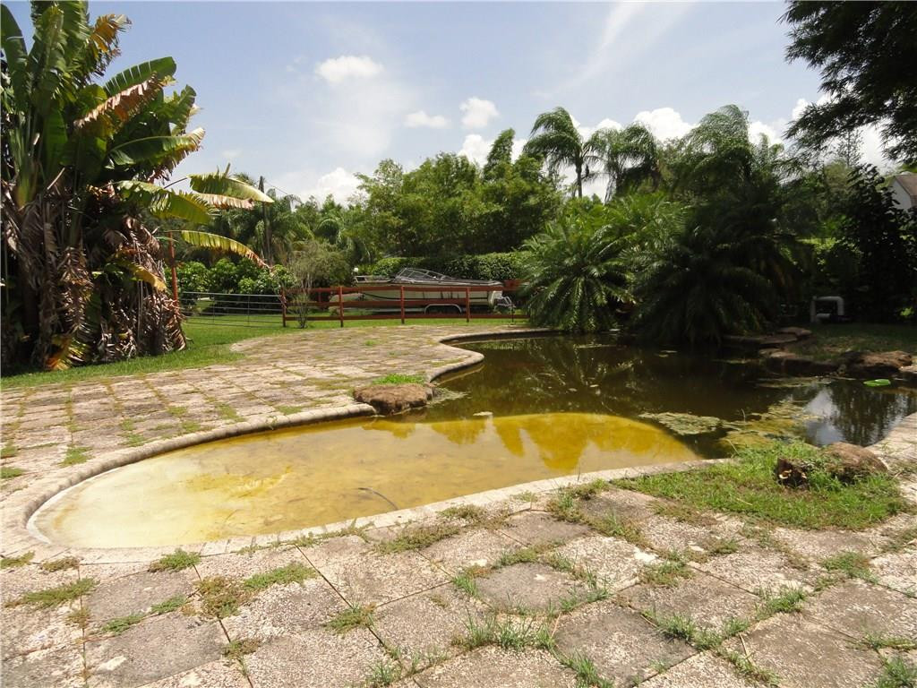 17950 Southwest 55th Street Southwest Ranches, FL 33331 - Photo 17 of 31 a view of a swimming pool with an outdoor space and seating area