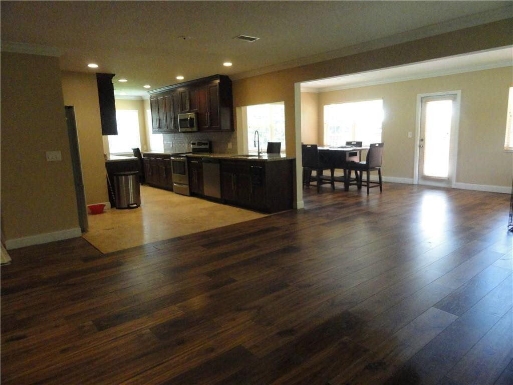 17950 Southwest 55th Street Southwest Ranches, FL 33331 - Photo 3 of 31 an open kitchen with kitchen island and stainless steel appliances