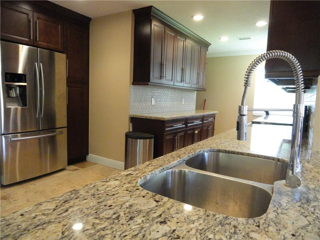 17950 Southwest 55th Street Southwest Ranches, FL 33331 - Photo 5 of 31 a kitchen with stainless steel appliances granite countertop a sink a refrigerator and a stove