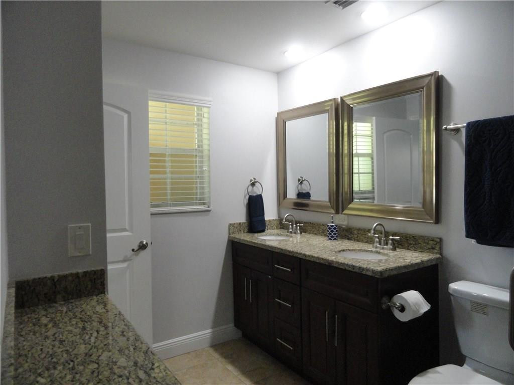 17950 Southwest 55th Street Southwest Ranches, FL 33331 - Photo 10 of 31 a bathroom with a granite countertop sink toilet and mirror