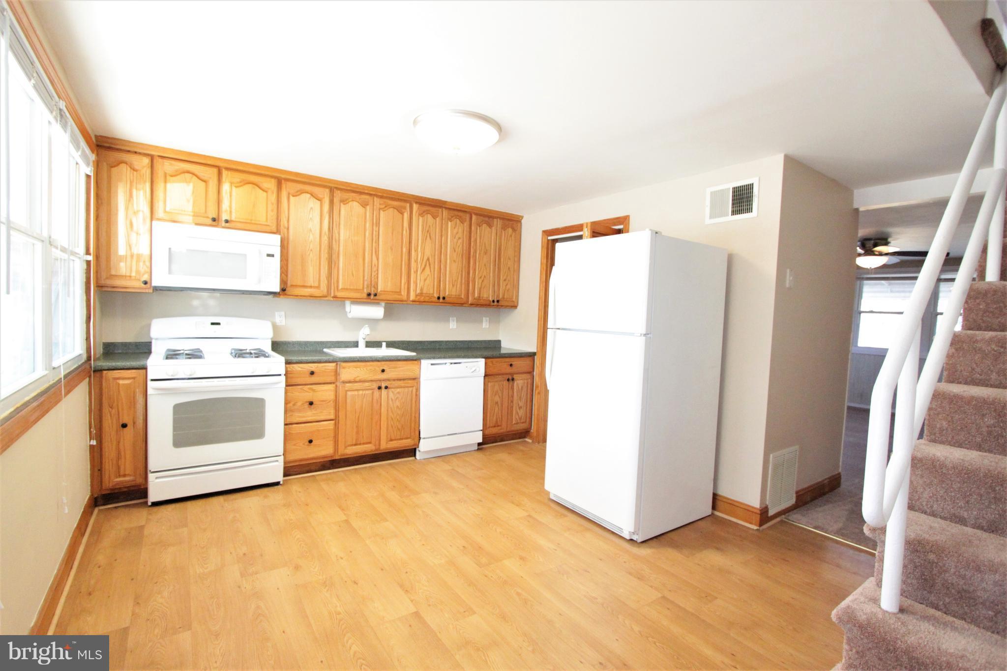 3111 Bero Road Baltimore, MD 21227 - Photo 2 of 25 a kitchen with a white cabinets and white appliances