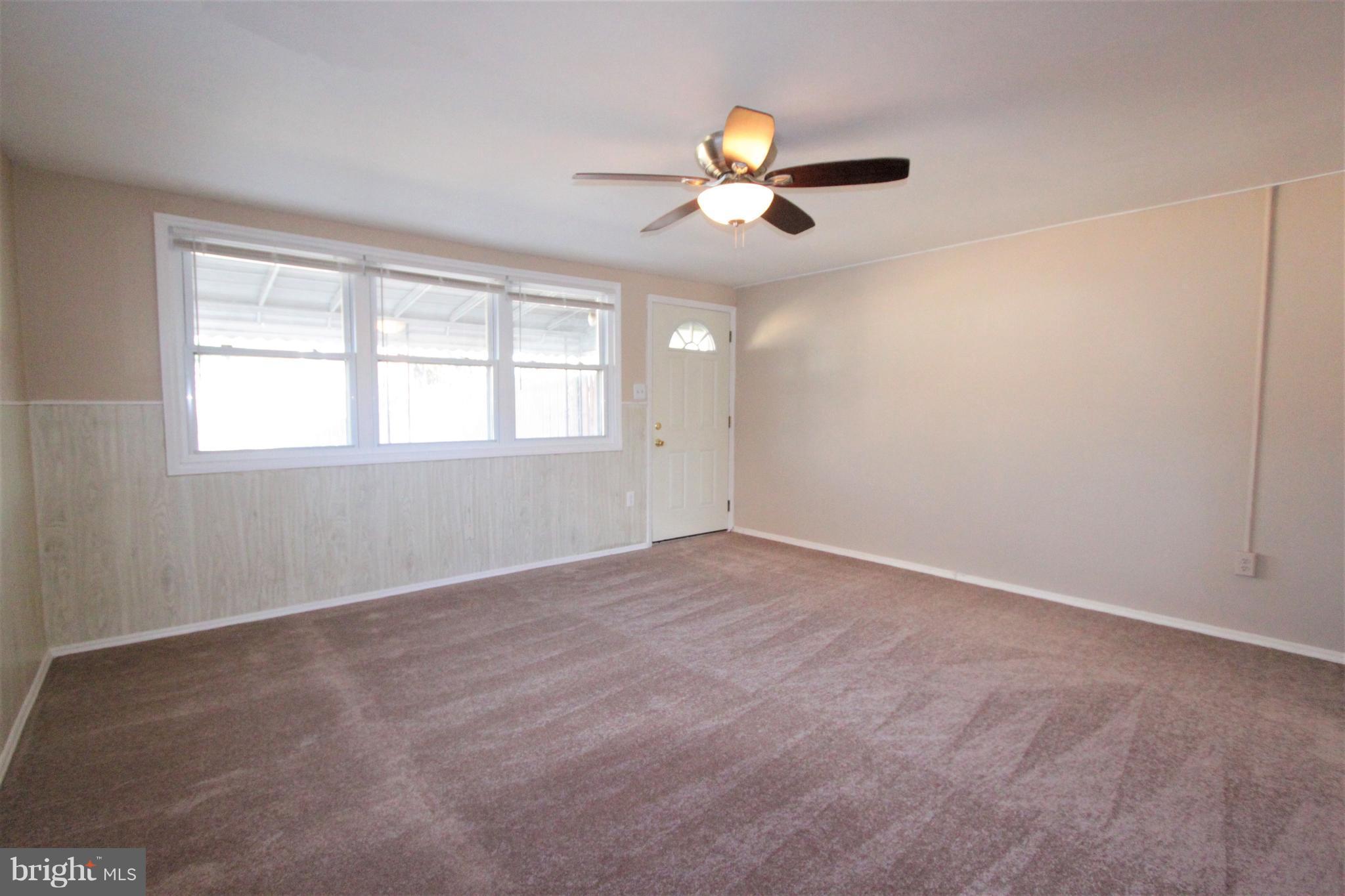 3111 Bero Road Baltimore, MD 21227 - Photo 14 of 25 an empty room with windows and fan