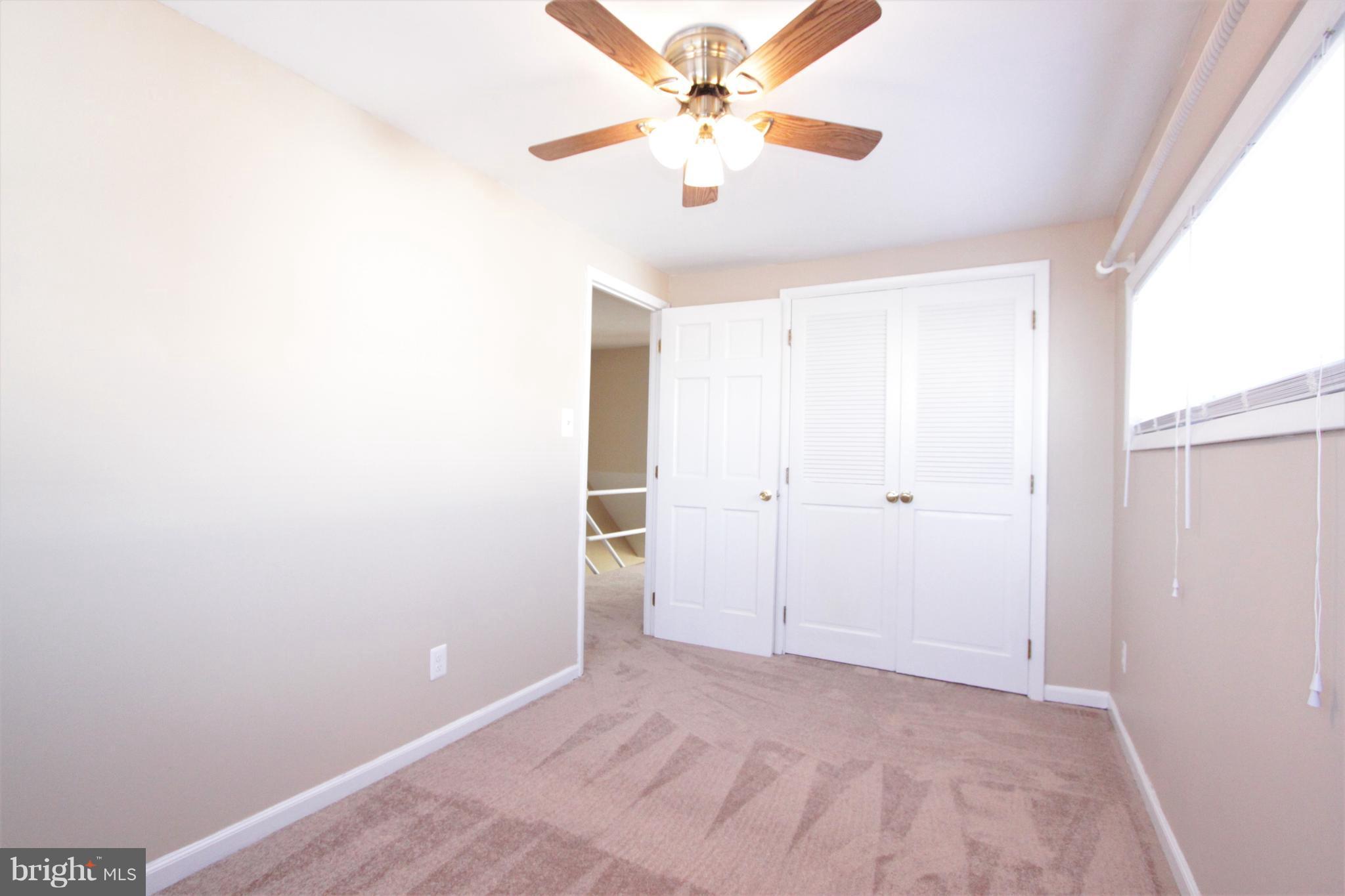 3111 Bero Road Baltimore, MD 21227 - Photo 18 of 25 a view of a room with a ceiling fan and a window