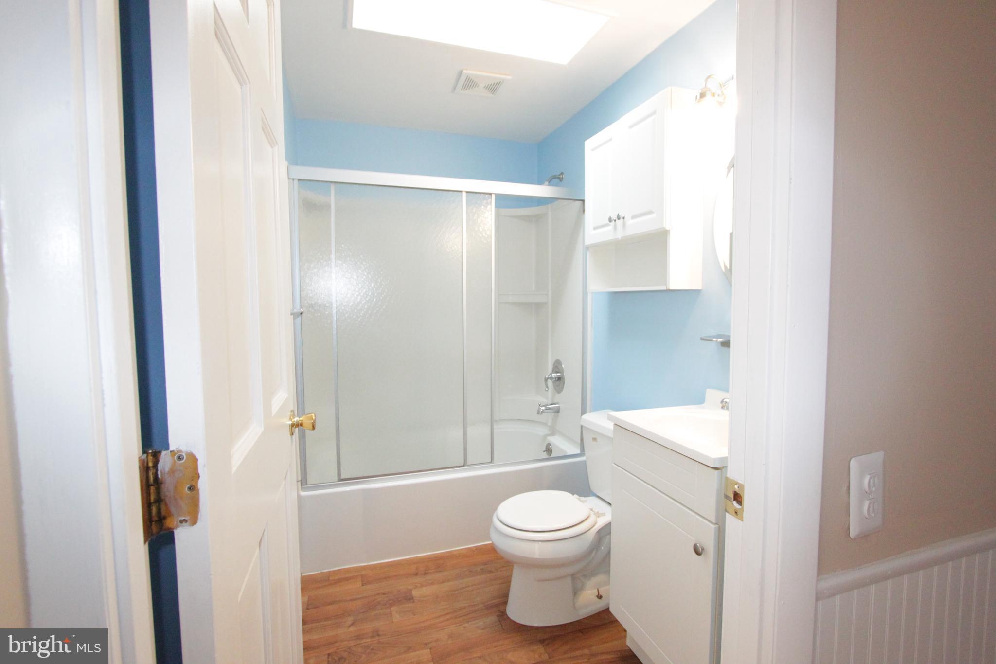 3111 Bero Road Baltimore, MD 21227 - Photo 3 of 25 a bathroom with a toilet a sink and shower