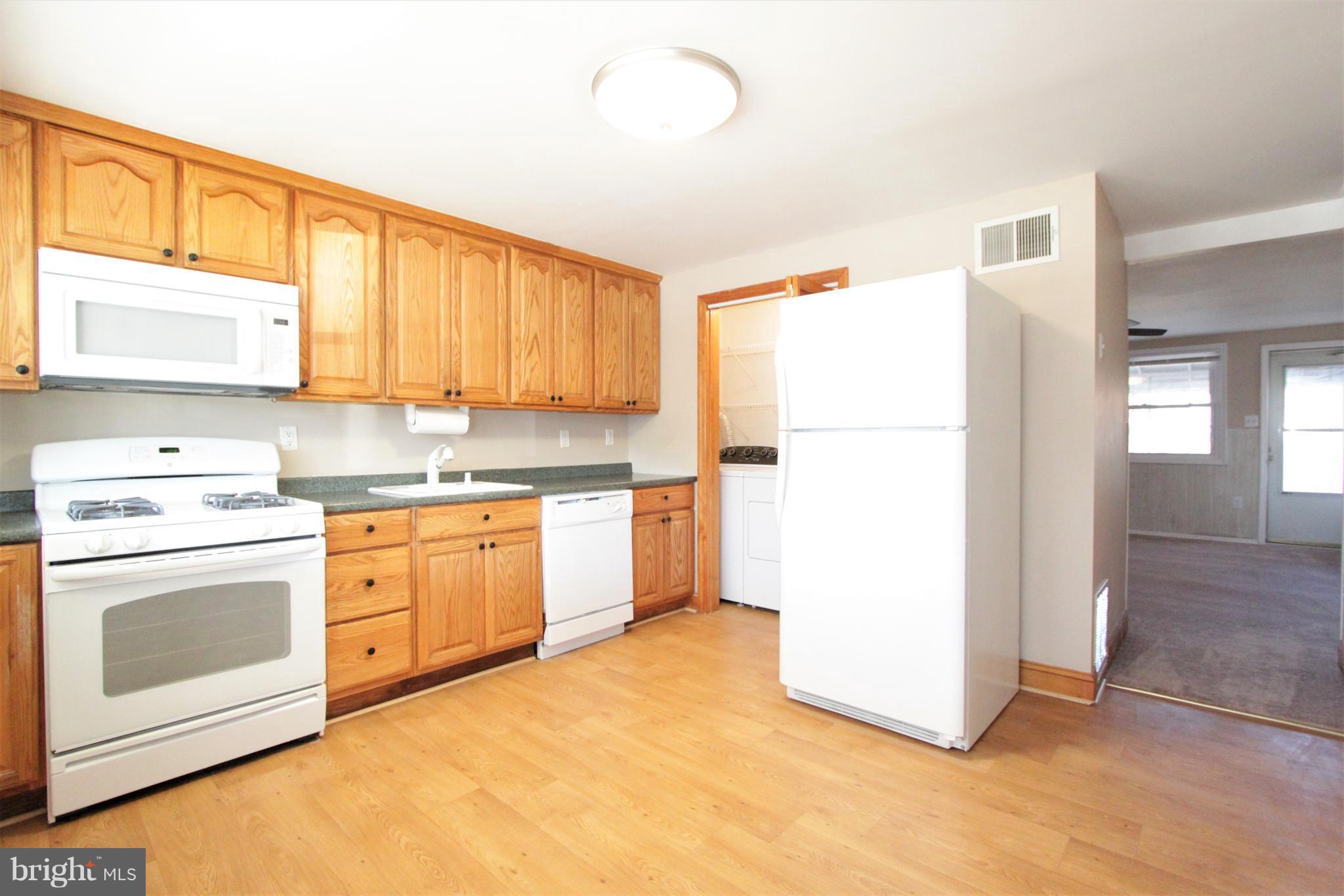 3111 Bero Road Baltimore, MD 21227 - Photo 23 of 25 a kitchen with a refrigerator sink stove and cabinets