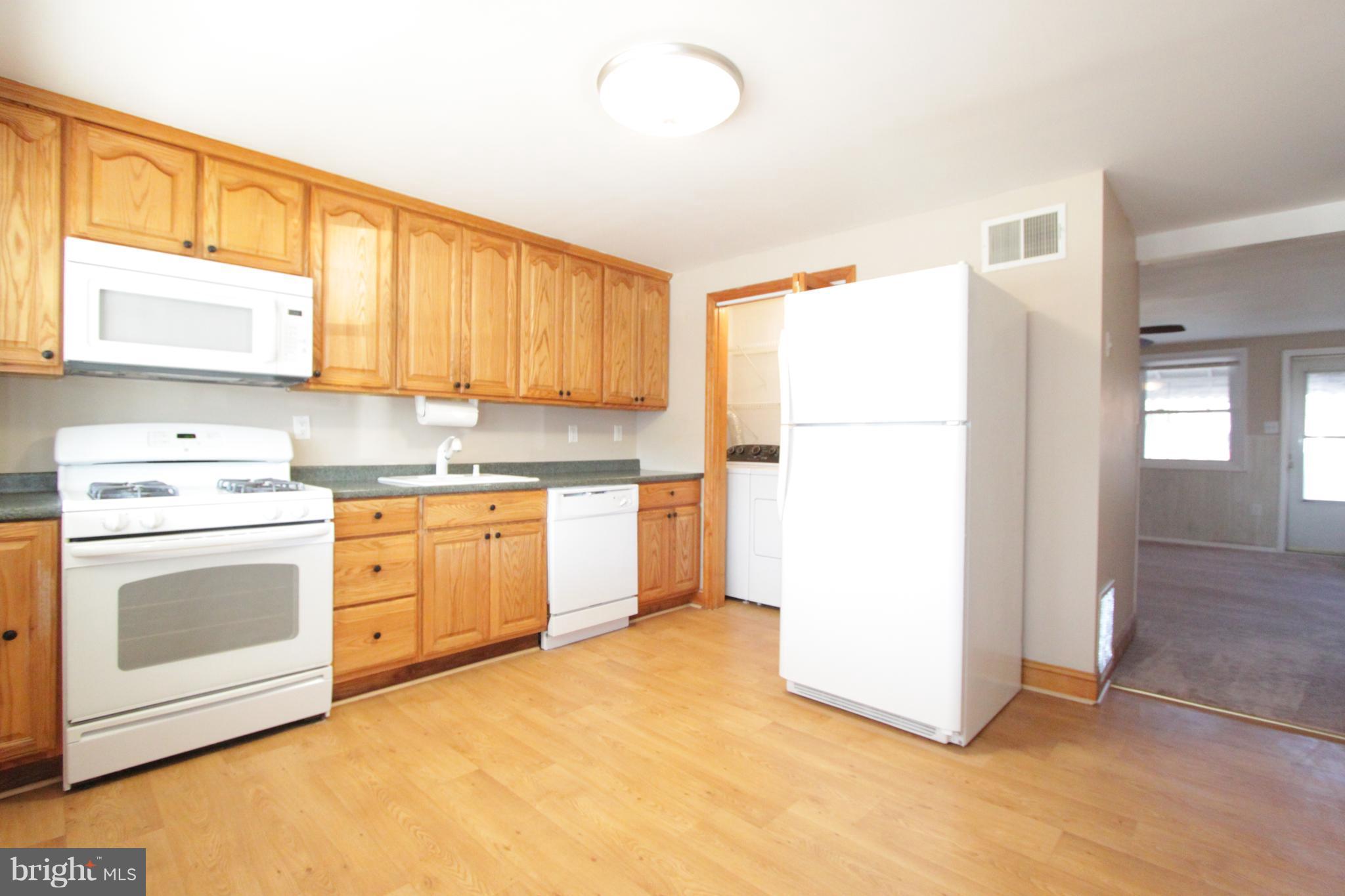 3111 Bero Road Baltimore, MD 21227 - Photo 25 of 25 a kitchen with a refrigerator sink stove and cabinets