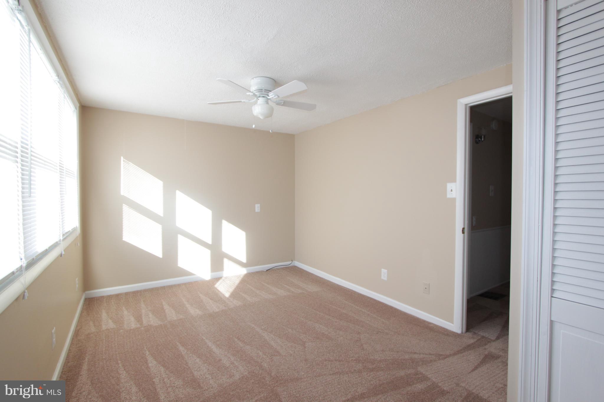 3111 Bero Road Baltimore, MD 21227 - Photo 5 of 25 wooden floor in an empty room with a window