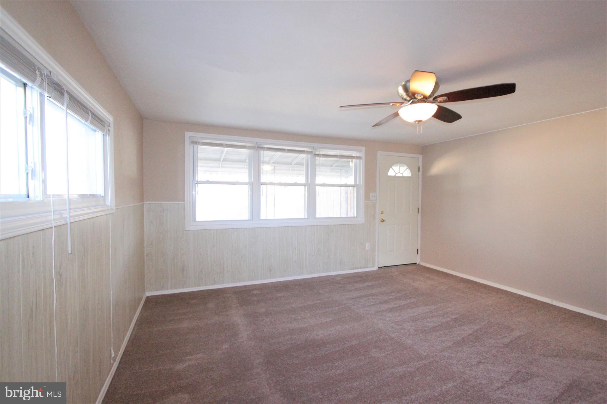 3111 Bero Road Baltimore, MD 21227 - Photo 6 of 25 wooden floor in an empty room with a window