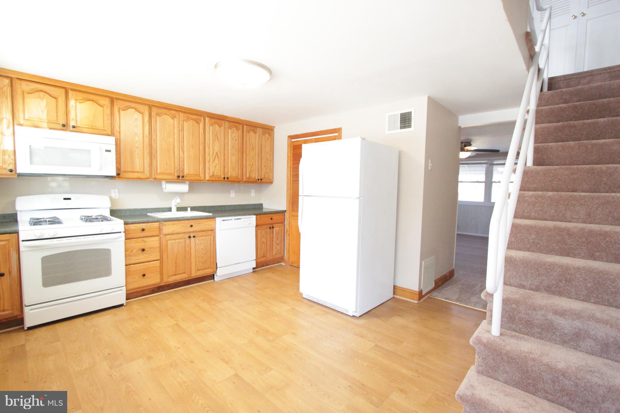 3111 Bero Road Baltimore, MD 21227 - Photo 8 of 25 a kitchen with a stove a sink and a refrigerator