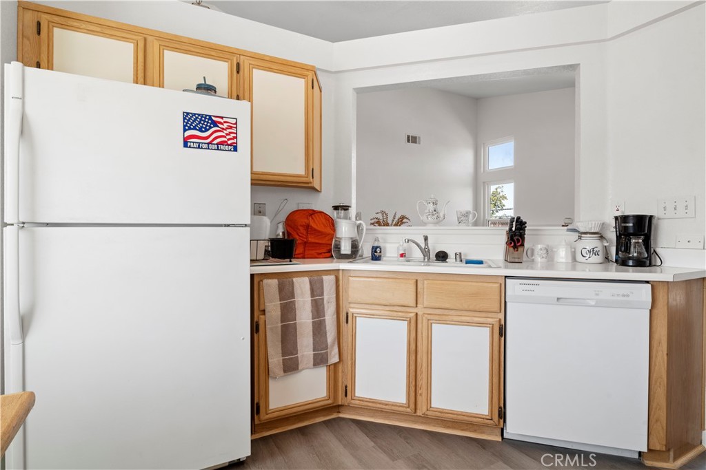 11688 Cornell Street Adelanto, CA 92301 - Photo 12 of 40 a utility room with cabinets washer and dryer