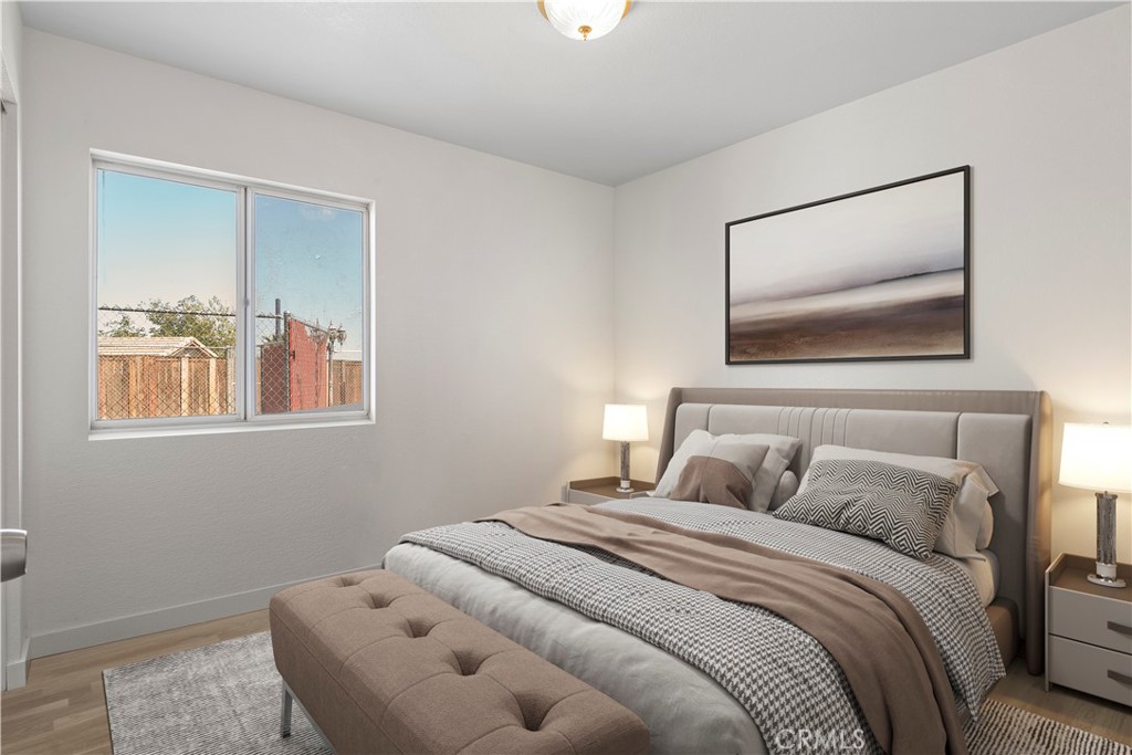 11688 Cornell Street Adelanto, CA 92301 - Photo 14 of 40 a bedroom with a bed and a painting on the wall