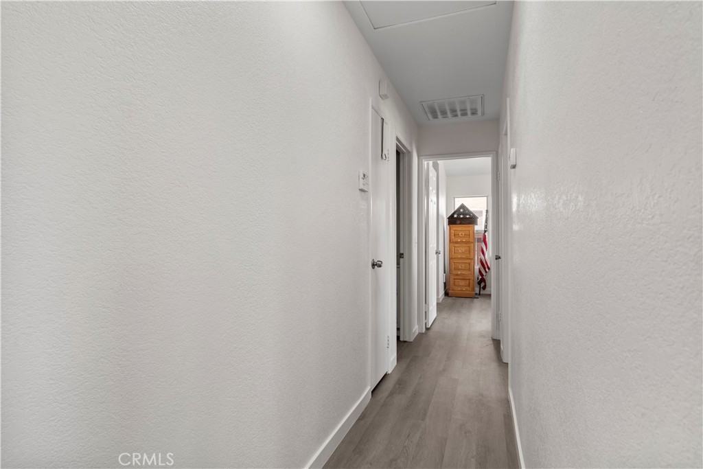 11688 Cornell Street Adelanto, CA 92301 - Photo 21 of 40 a view of a hallway with wooden floor