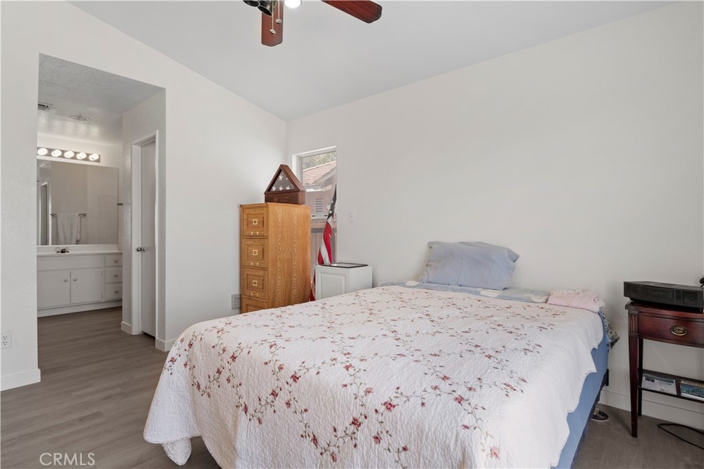 11688 Cornell Street Adelanto, CA 92301 - Photo 23 of 40 a bedroom with a bed and a chandelier