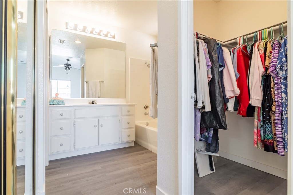 11688 Cornell Street Adelanto, CA 92301 - Photo 25 of 40 a view of walk in closet with clothes