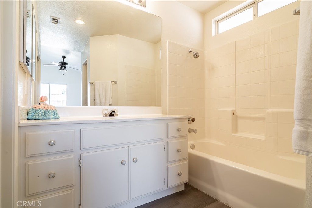 11688 Cornell Street Adelanto, CA 92301 - Photo 26 of 40 a bathroom with a double vanity sink a mirror and a bathtub