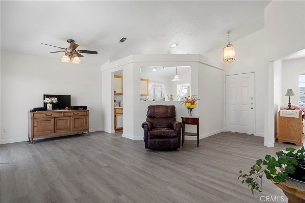 11688 Cornell Street Adelanto, CA 92301 - Photo 7 of 40 a living room with furniture and a chandelier