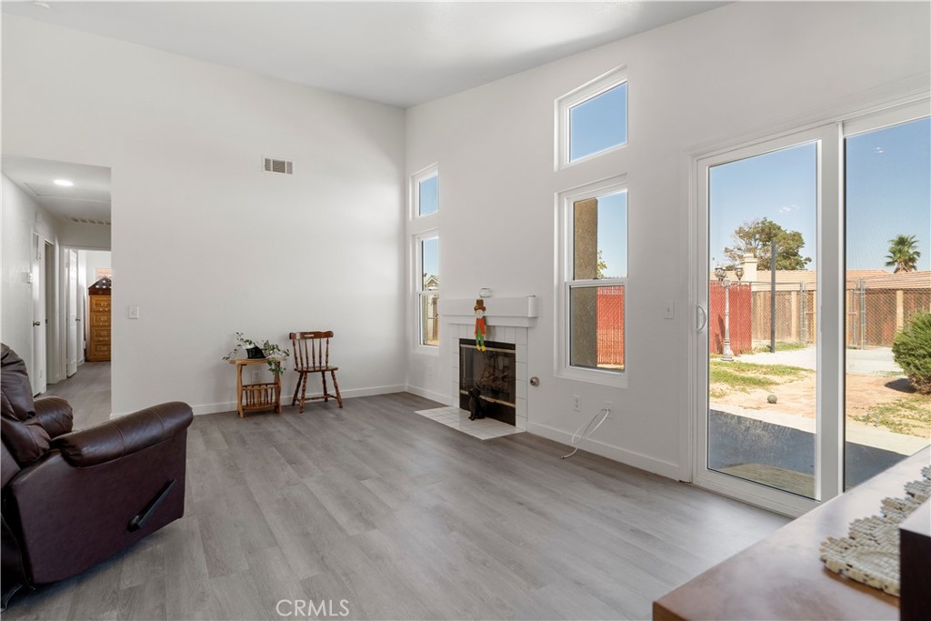 11688 Cornell Street Adelanto, CA 92301 - Photo 8 of 40 a living room with furniture and a flat screen tv