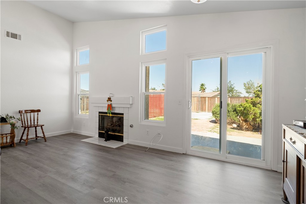 11688 Cornell Street Adelanto, CA 92301 - Photo 9 of 40 wooden floor in an empty room with a window