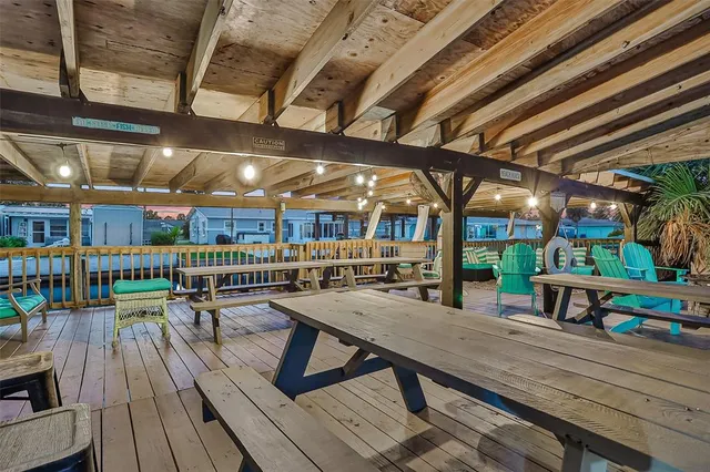 a view of a two chairs and table in the back yard of the house