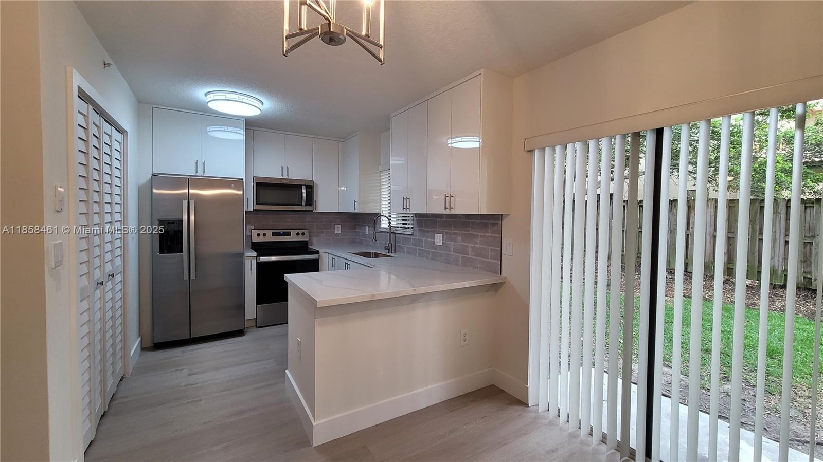 a kitchen with refrigerator and cabinets
