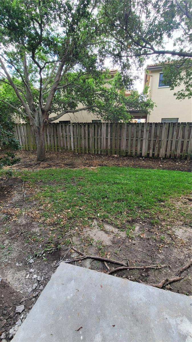 22731 Southwest 88th Place, Unit 101 Cutler Bay, FL 33190 - Photo 21 of 59 a view of a backyard with wooden fence