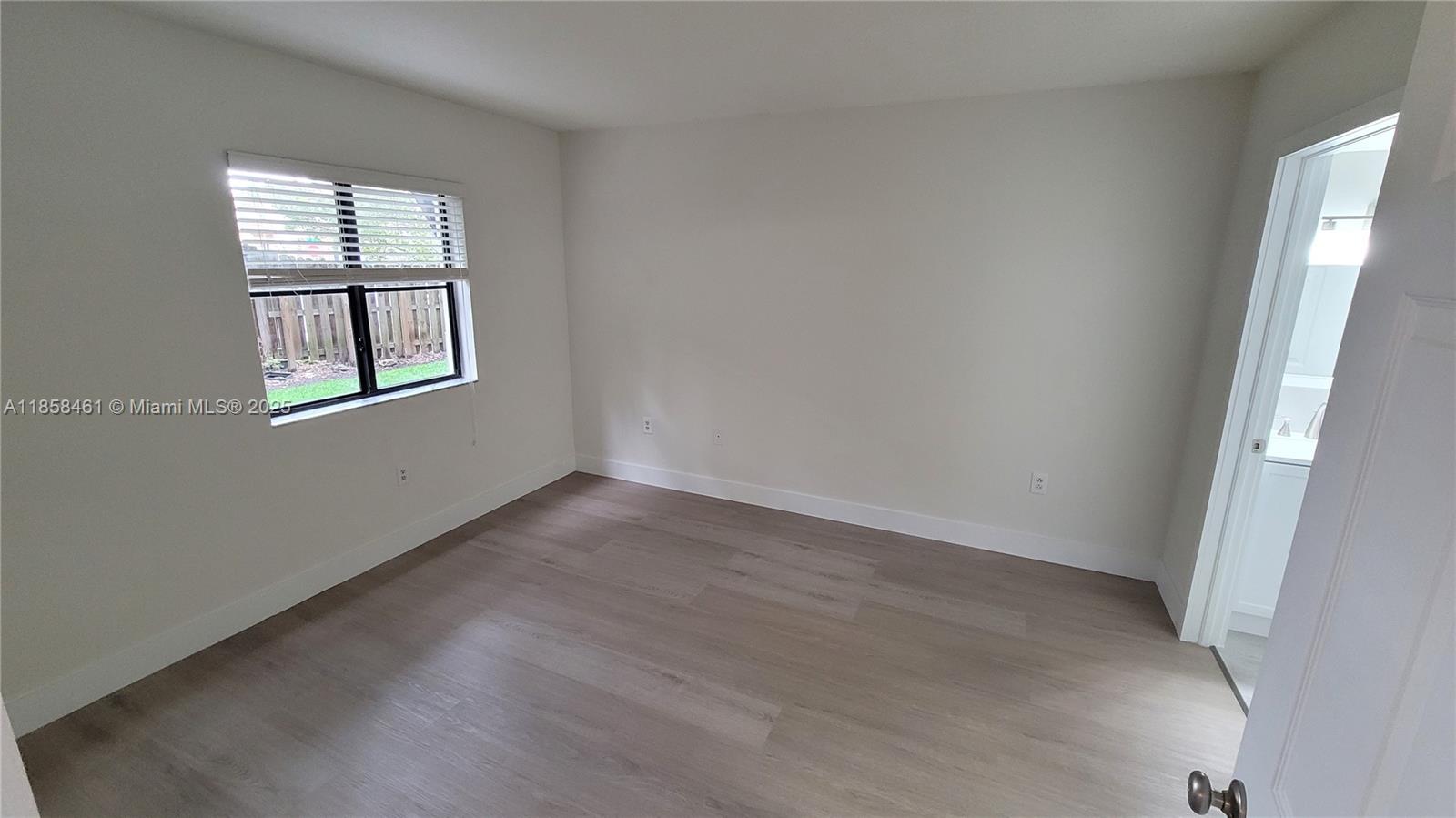 22731 Southwest 88th Place, Unit 101 Cutler Bay, FL 33190 - Photo 22 of 59 an empty room with a window