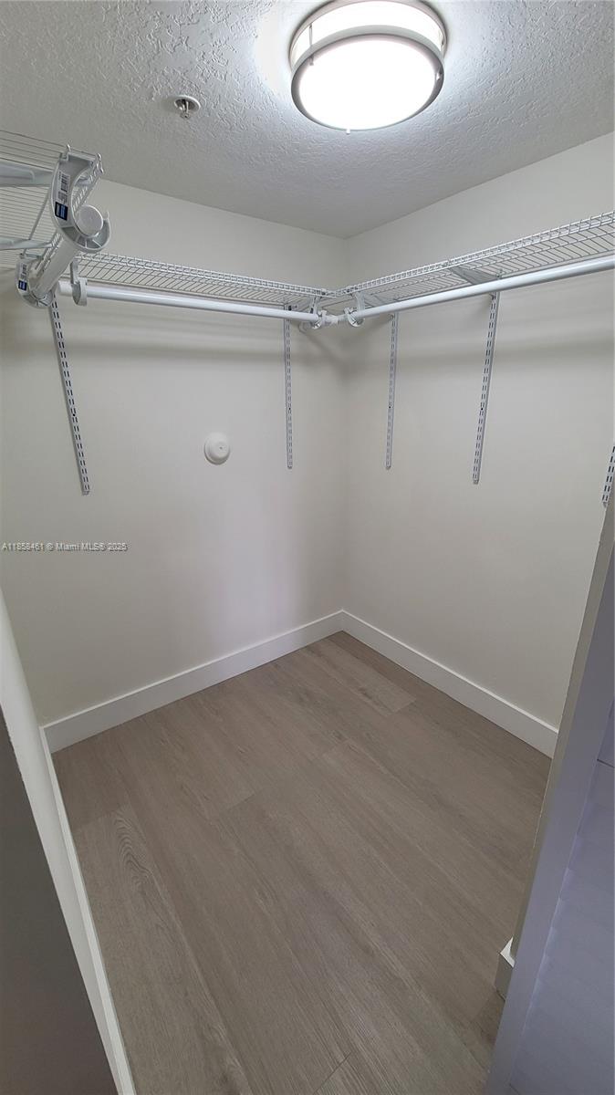 22731 Southwest 88th Place, Unit 101 Cutler Bay, FL 33190 - Photo 24 of 59 a view of a room with racks on the wall
