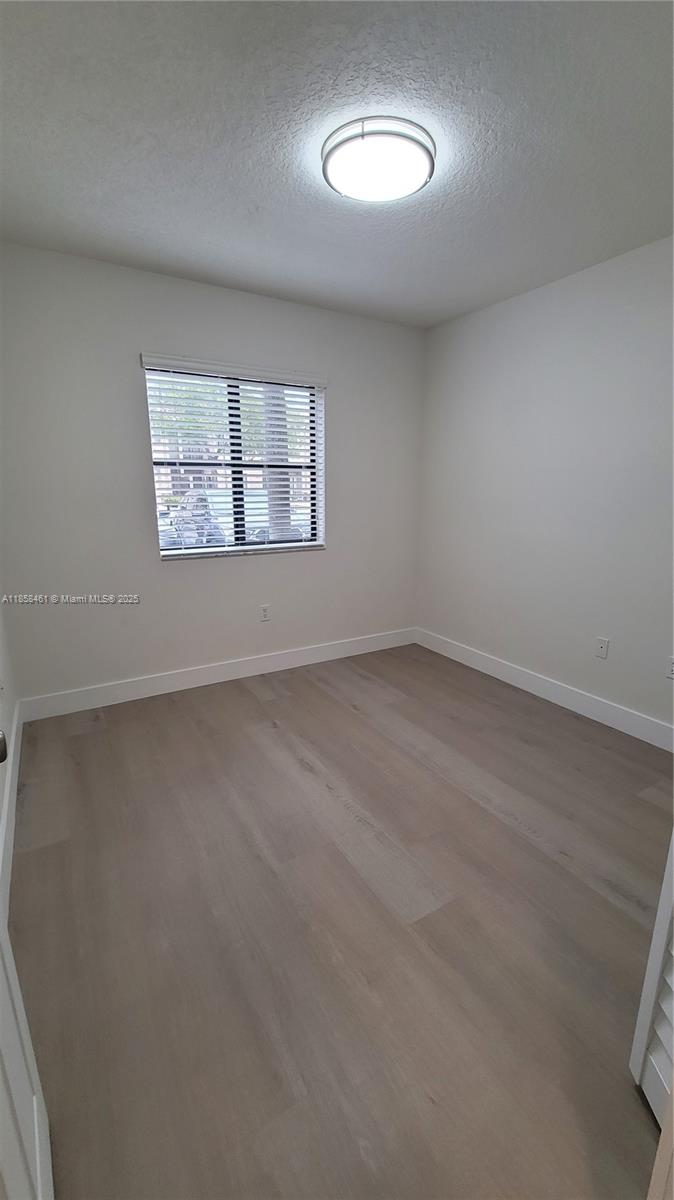 22731 Southwest 88th Place, Unit 101 Cutler Bay, FL 33190 - Photo 33 of 59 an empty room with a window
