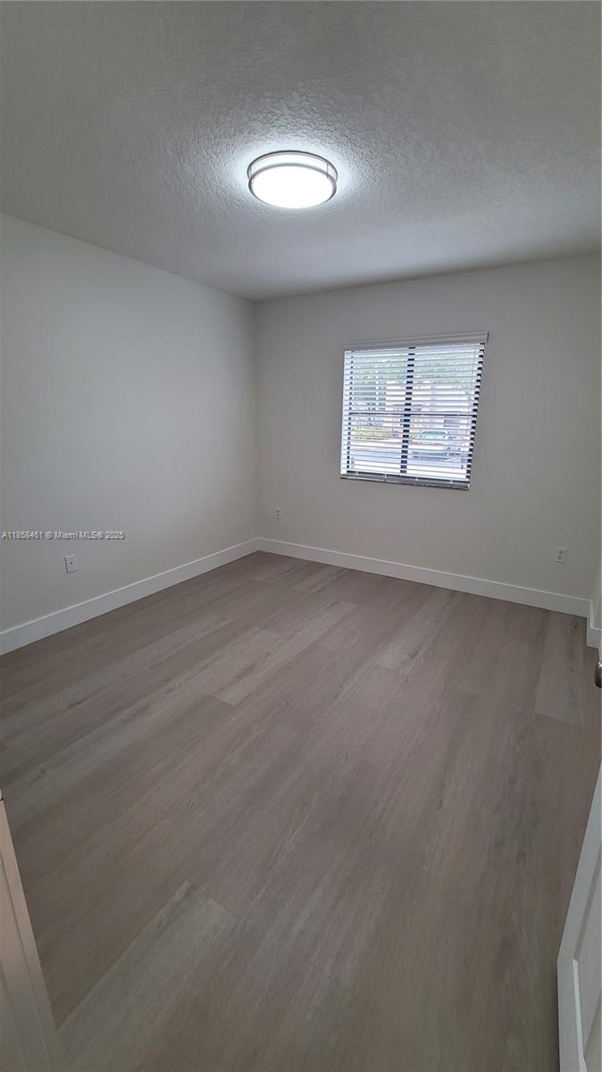 22731 Southwest 88th Place, Unit 101 Cutler Bay, FL 33190 - Photo 35 of 59 an empty room with a window