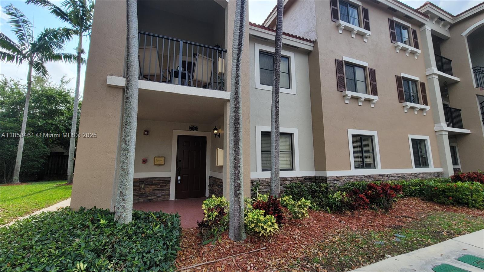 22731 Southwest 88th Place, Unit 101 Cutler Bay, FL 33190 - Photo 40 of 59 a view of a house with brick walls plants and large tree