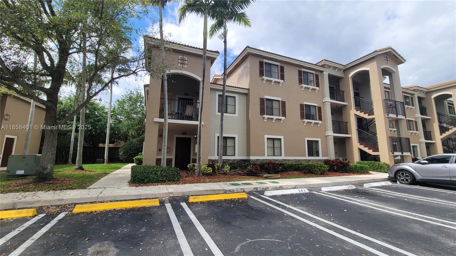 22731 Southwest 88th Place, Unit 101 Cutler Bay, FL 33190 - Photo 41 of 59 a front view of residential houses with yard