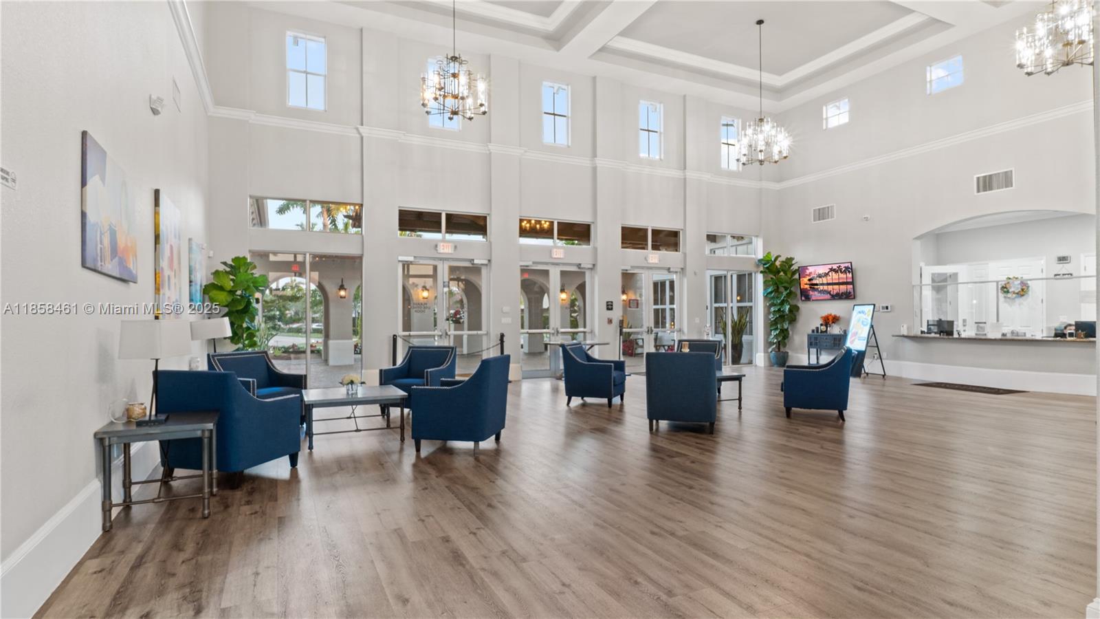 22731 Southwest 88th Place, Unit 101 Cutler Bay, FL 33190 - Photo 46 of 59 a living room with furniture wooden floor and a chandelier