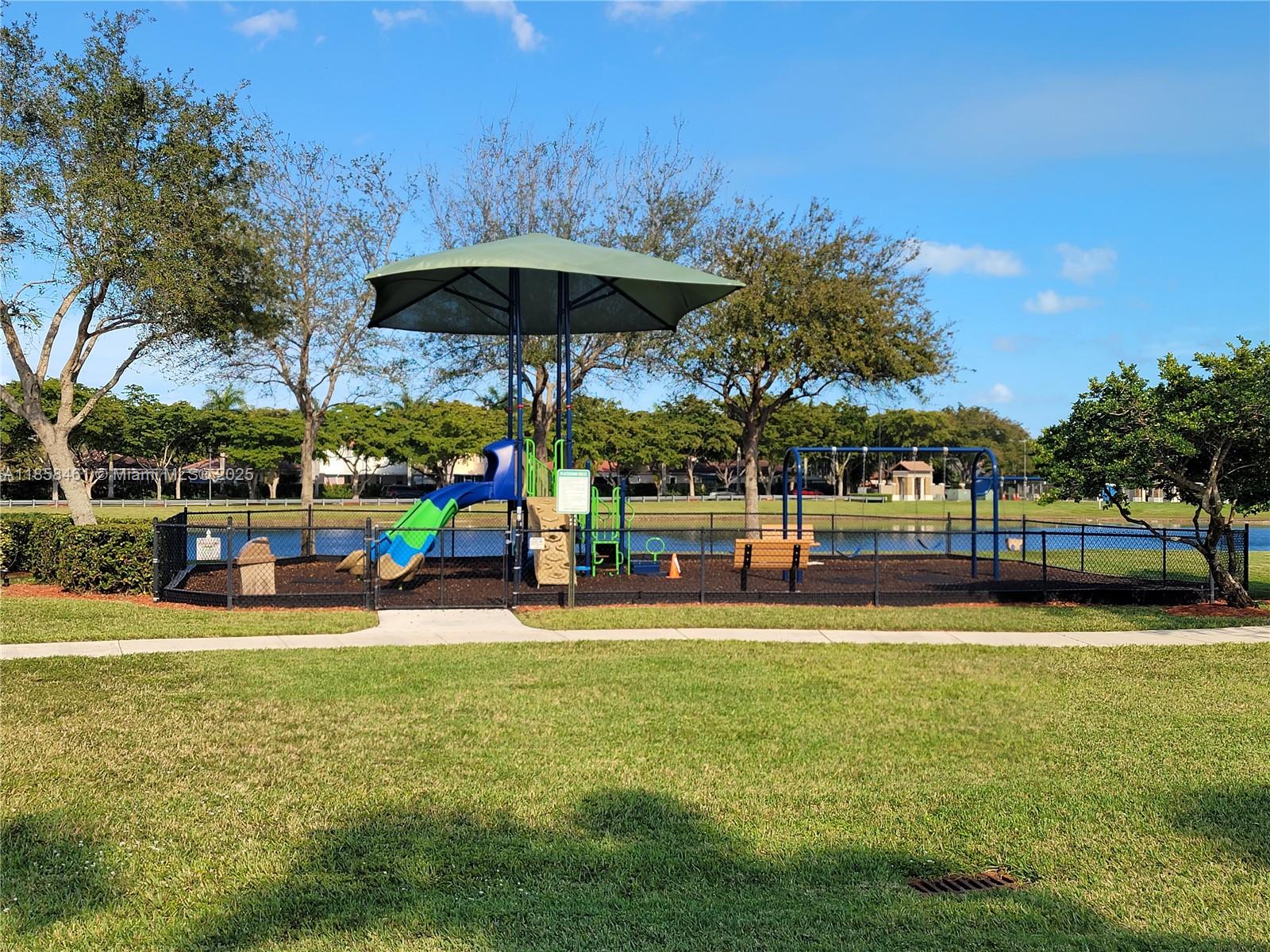 22731 Southwest 88th Place, Unit 101 Cutler Bay, FL 33190 - Photo 49 of 59 a view of a swimming pool with an outdoor seating