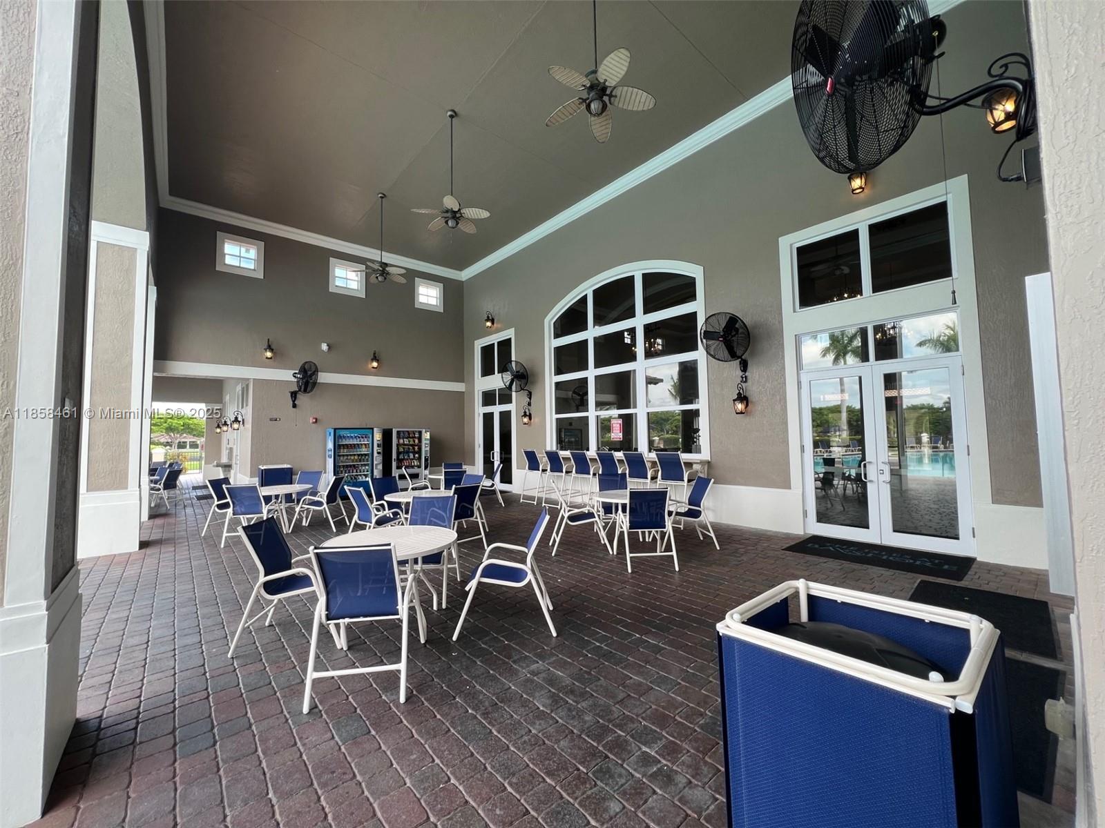 22731 Southwest 88th Place, Unit 101 Cutler Bay, FL 33190 - Photo 55 of 59 a dining room with furniture window and wooden floor