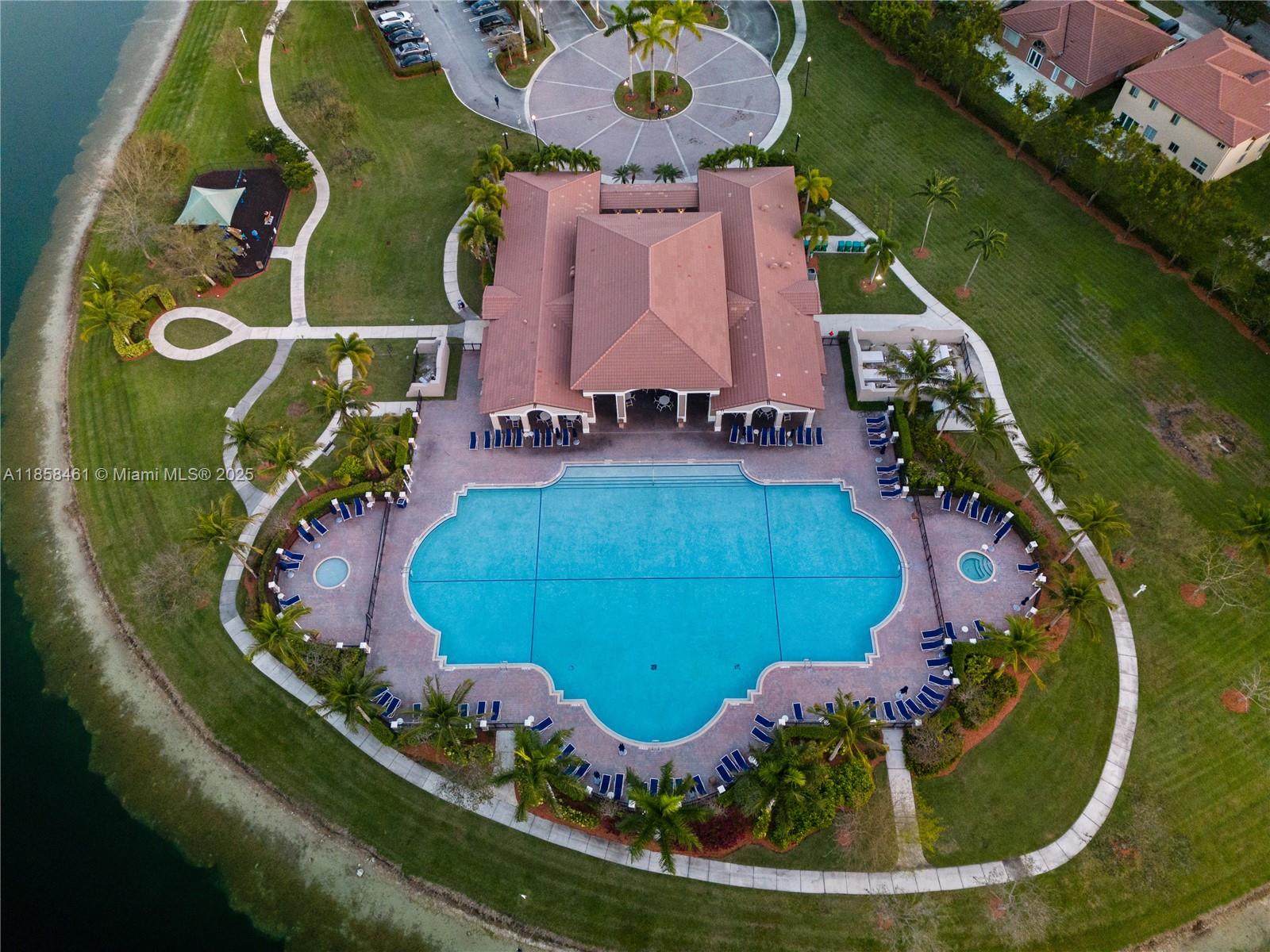 22731 Southwest 88th Place, Unit 101 Cutler Bay, FL 33190 - Photo 58 of 59 an aerial view of a swimming pool patio and outdoor seating
