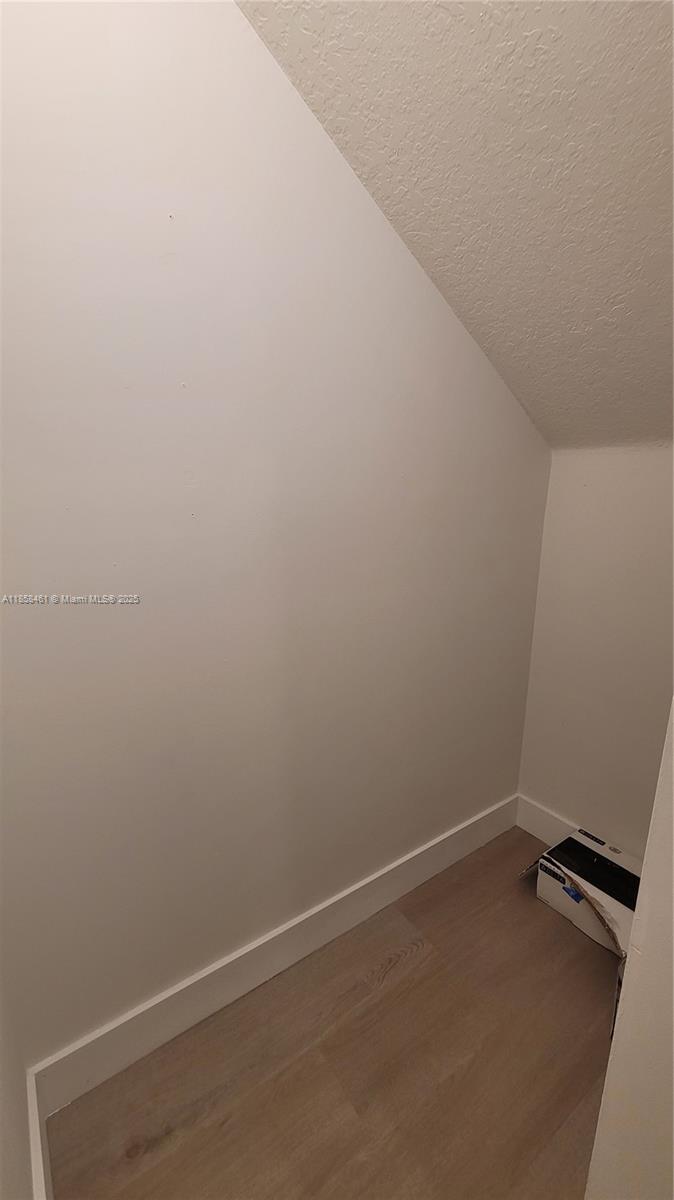 22731 Southwest 88th Place, Unit 101 Cutler Bay, FL 33190 - Photo 6 of 59 an empty room with a bench