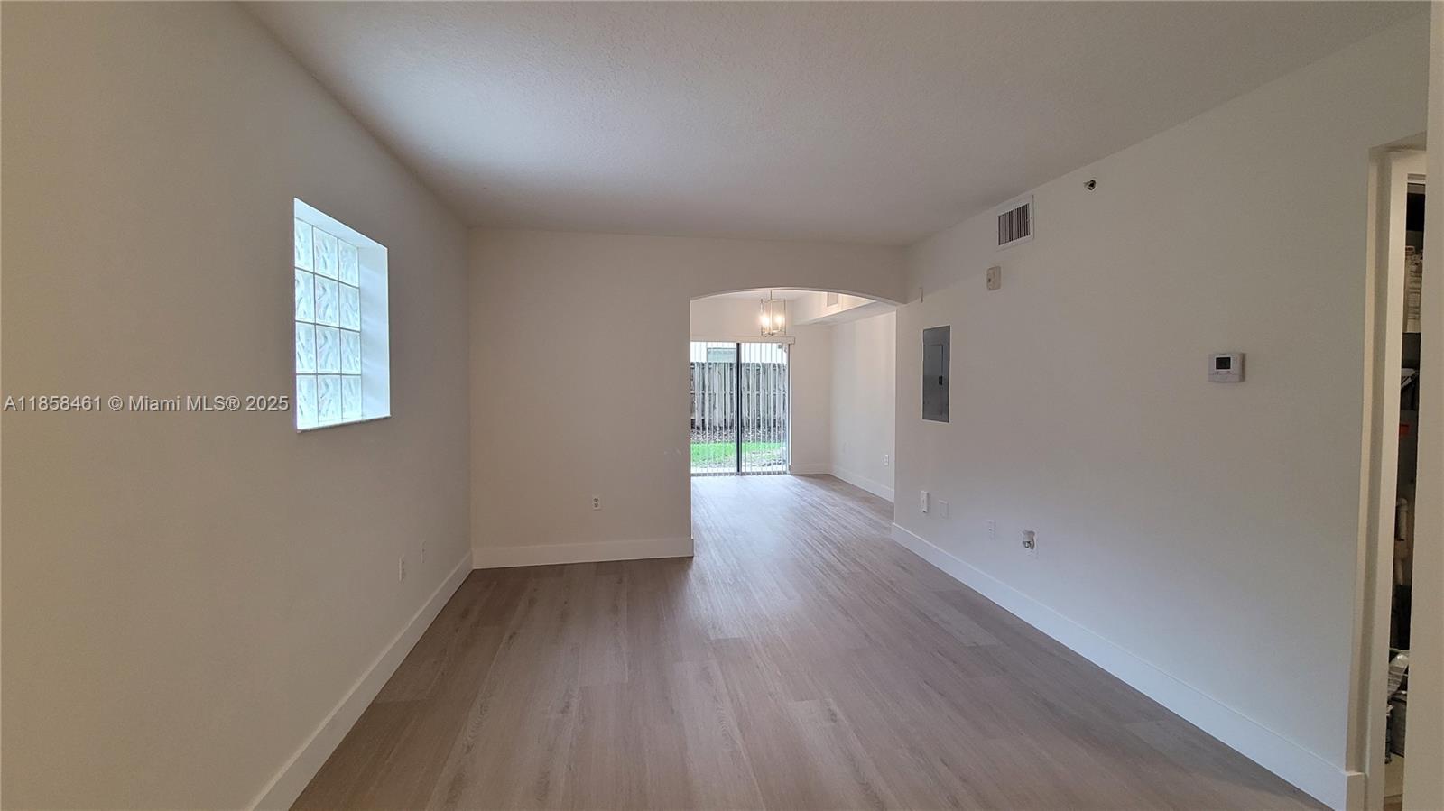 22731 Southwest 88th Place, Unit 101 Cutler Bay, FL 33190 - Photo 7 of 59 a view of a room with wooden floor and window