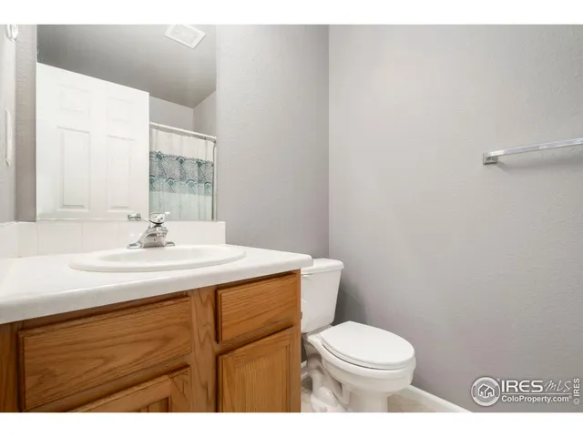 a bathroom with a sink toilet and a mirror