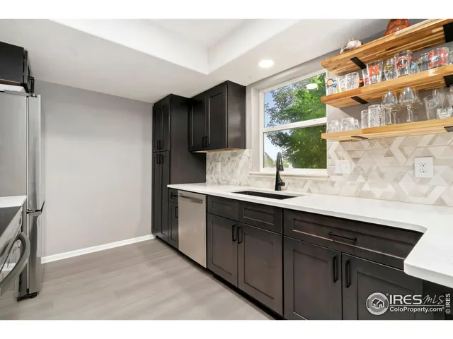 a kitchen with a sink cabinets and a window