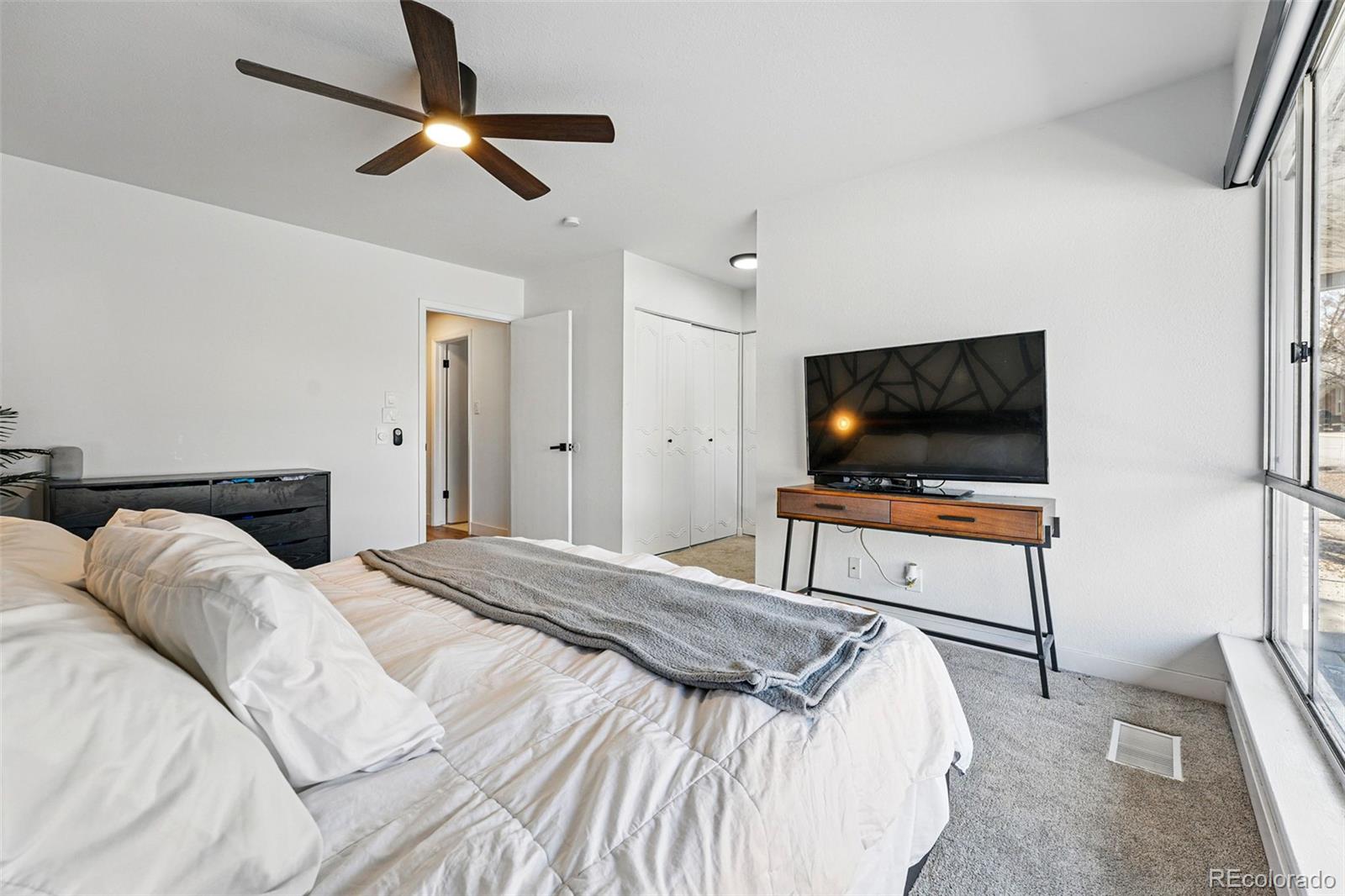 6495 East Happy Canyon Road, Unit 62 Denver, CO 80237 - Photo 14 of 23 a bedroom with a bed and a flat screen tv